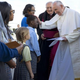 Pope Francis with a student at Our Lady Queen of Angels School Friday in New York City's East Harlem community
Craig Ruttle/pool